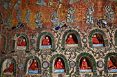 Myanmar, Burma, Nyaungshwe. Small Buddhas set into the temple wall, Shwe Yaunghwe Kyaung monastery, near Inle Lake. 